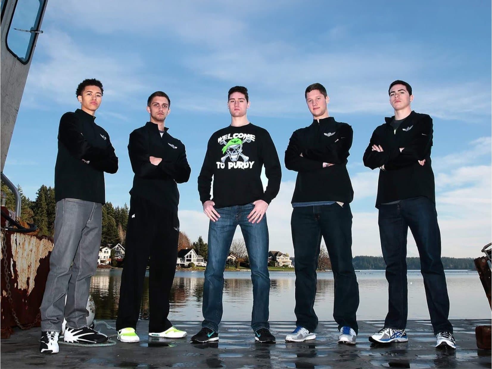 Five Peninsula High School basketball seniors standing on a Minterbrook barge with Minter Bay behind them